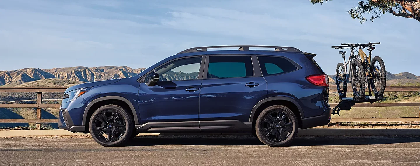 Subaru driving down a road