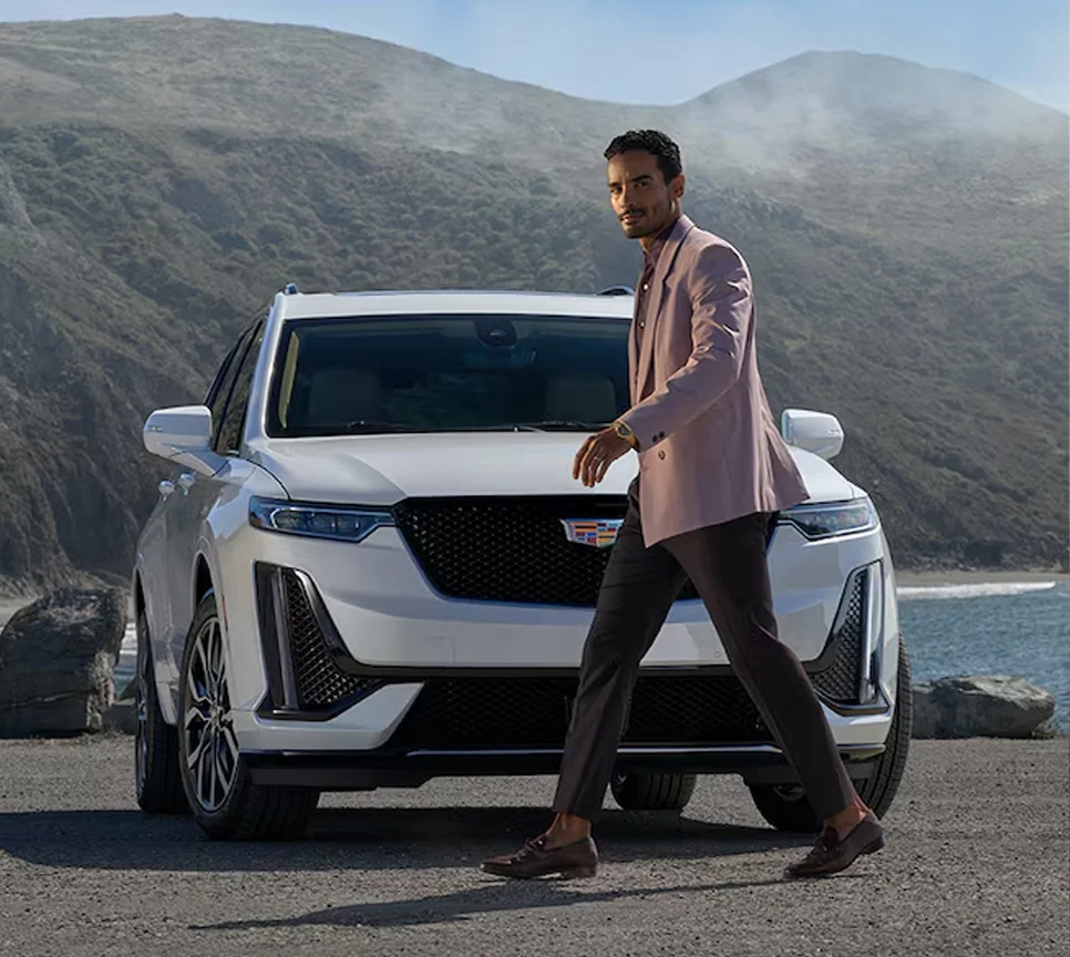 Man Walking In front of Cadillac