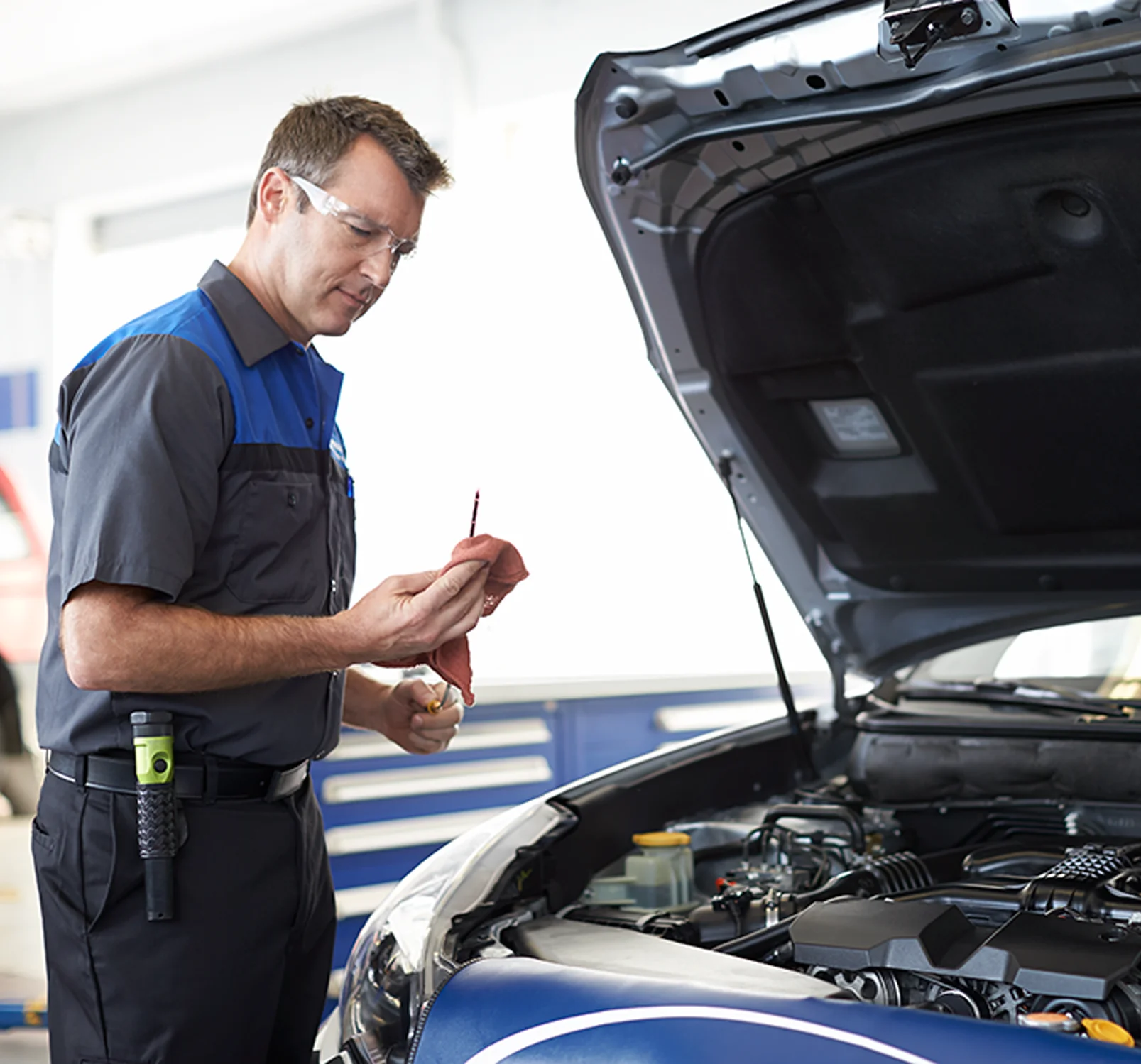 Subaru Service Subaru service tech working on a car