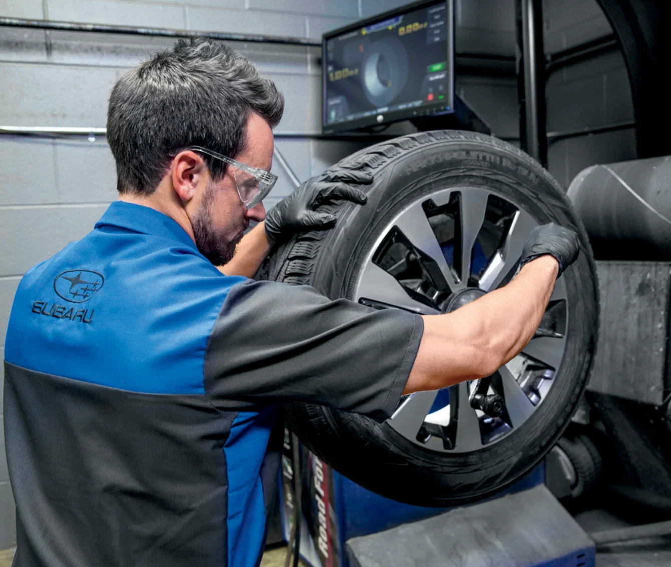 Subaru Service Subaru Tech Working With Tire