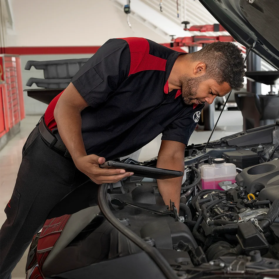 Toyota service technician inspection under the hood