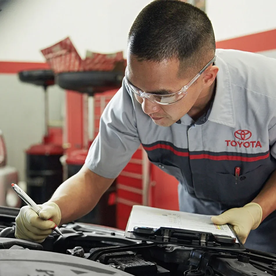 Toyota service technician inspection under the hood