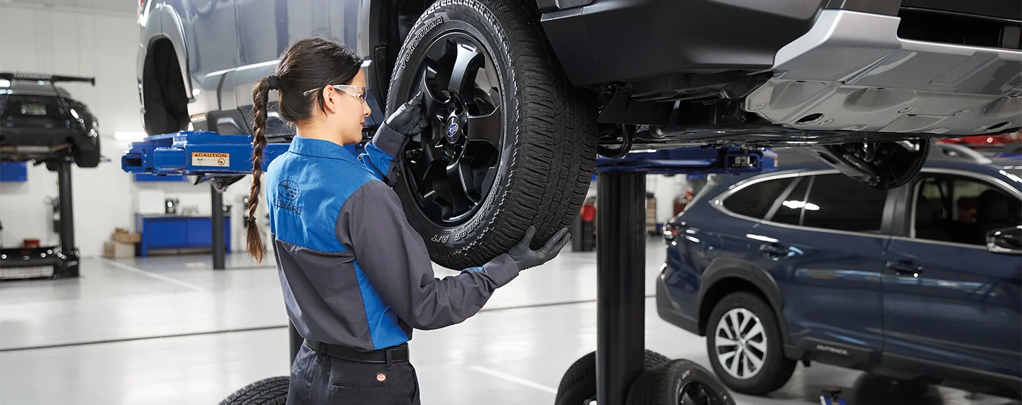 Subaru Service Tech working on a car