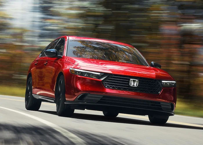 Honda Accord driving down a road