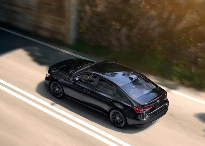 Honda Civic driving down a road from above