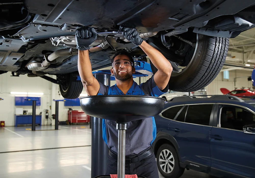 Subaru Tech working under a car