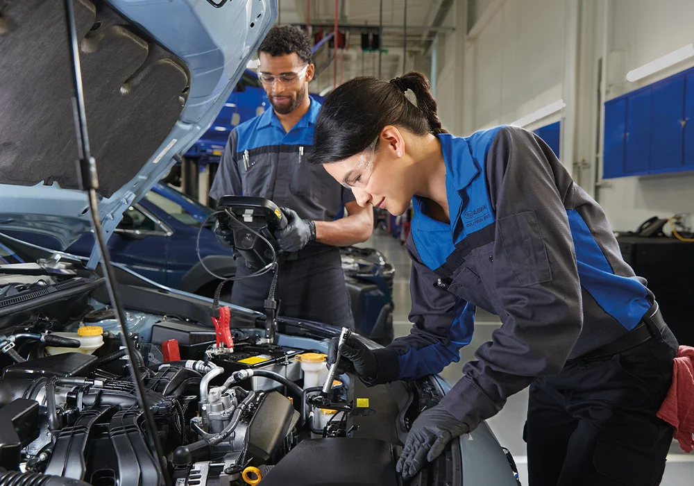 Subaru Tech looking under a hood
